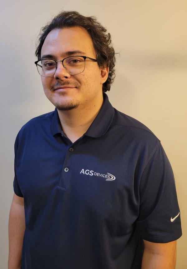 Lucas Angelini, General Manager at AGS Devices, in a blue AGS Devices t-shirt.