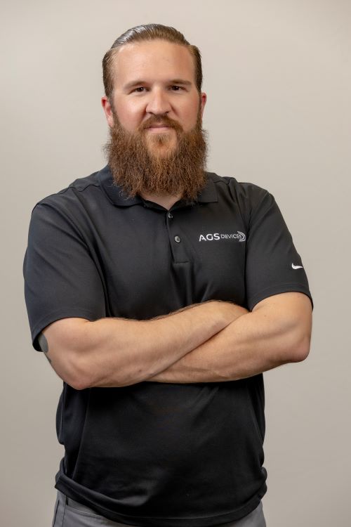 CJ McHugh, AGS Devices Corporate Sales Manager, in a black branded t-shirt.