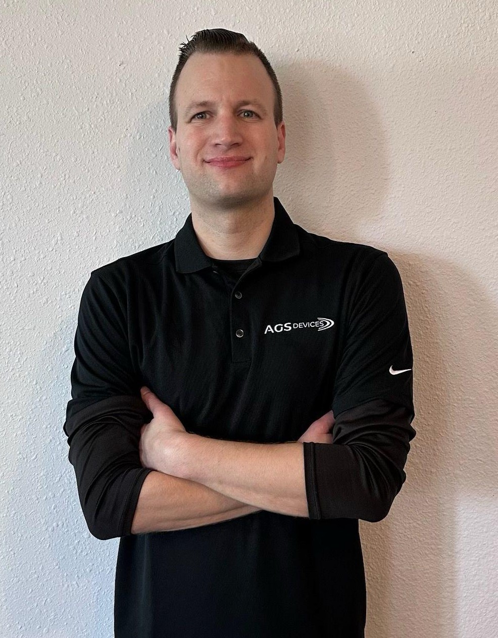 Drew McAleenan, Aerospace Strategic Growth Manager at AGS, in a black branded shirt.