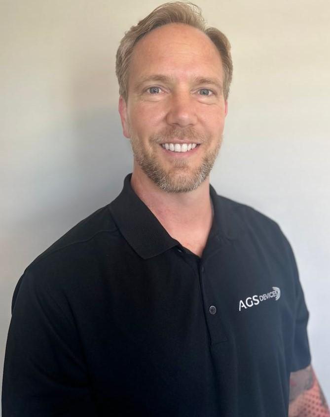 Kalen Johnson, Senior Accounts Manager at AGS Devices, in a branded black t-shirt.