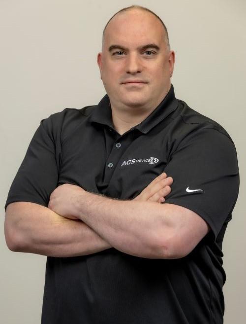 Thomas Mandell, purchasing manager at AGS Devices, in a black branded t-shirt.